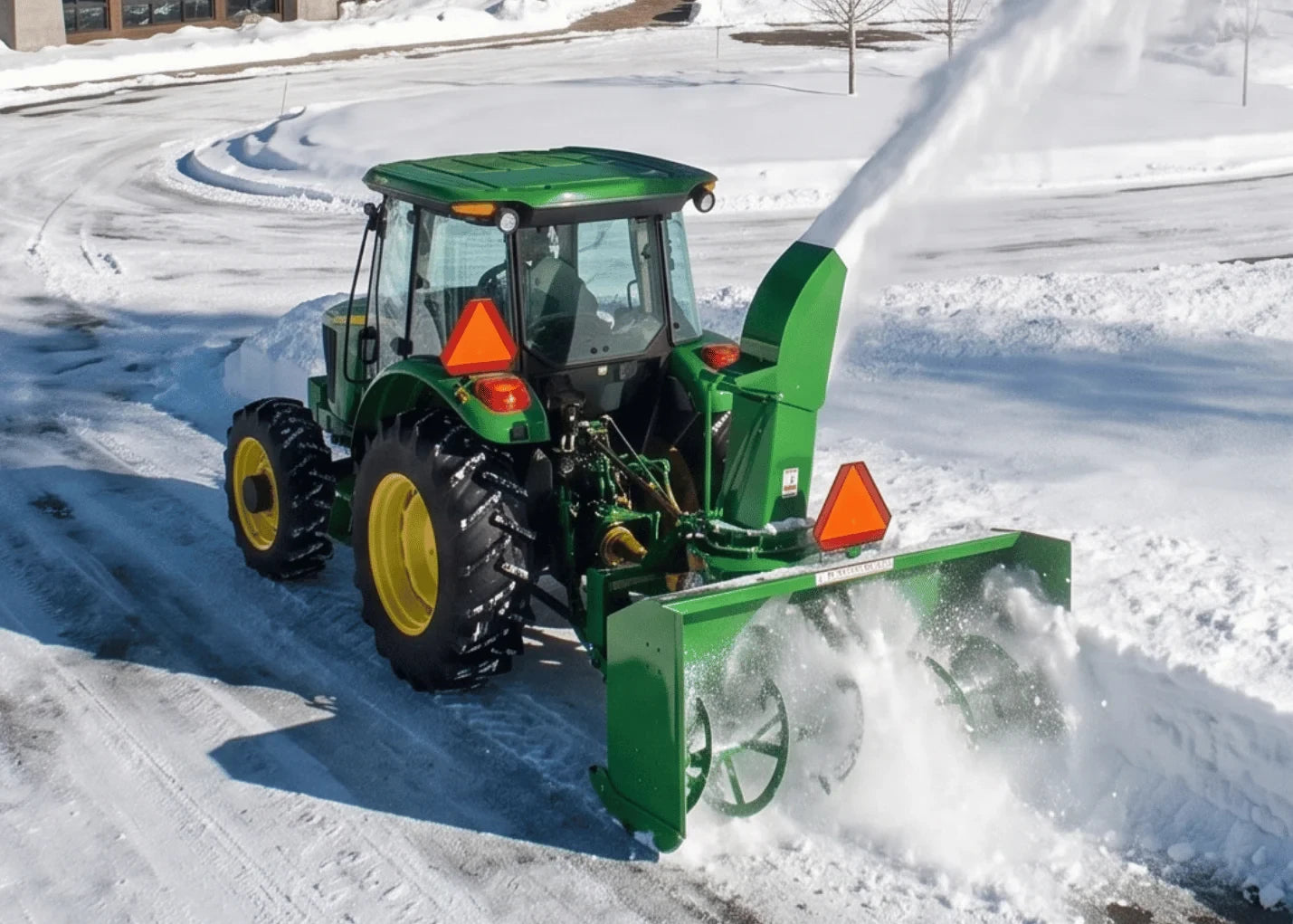 John Deere tractor with a snowblower at work