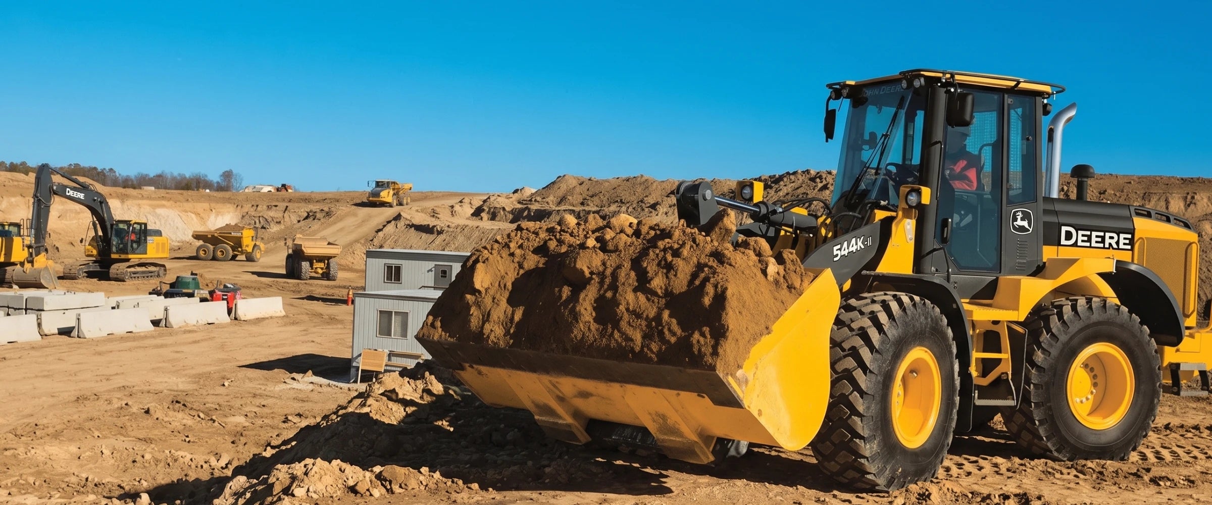 Chargeuse sur roues John Deere 544 sur un grand chantier de terrassement