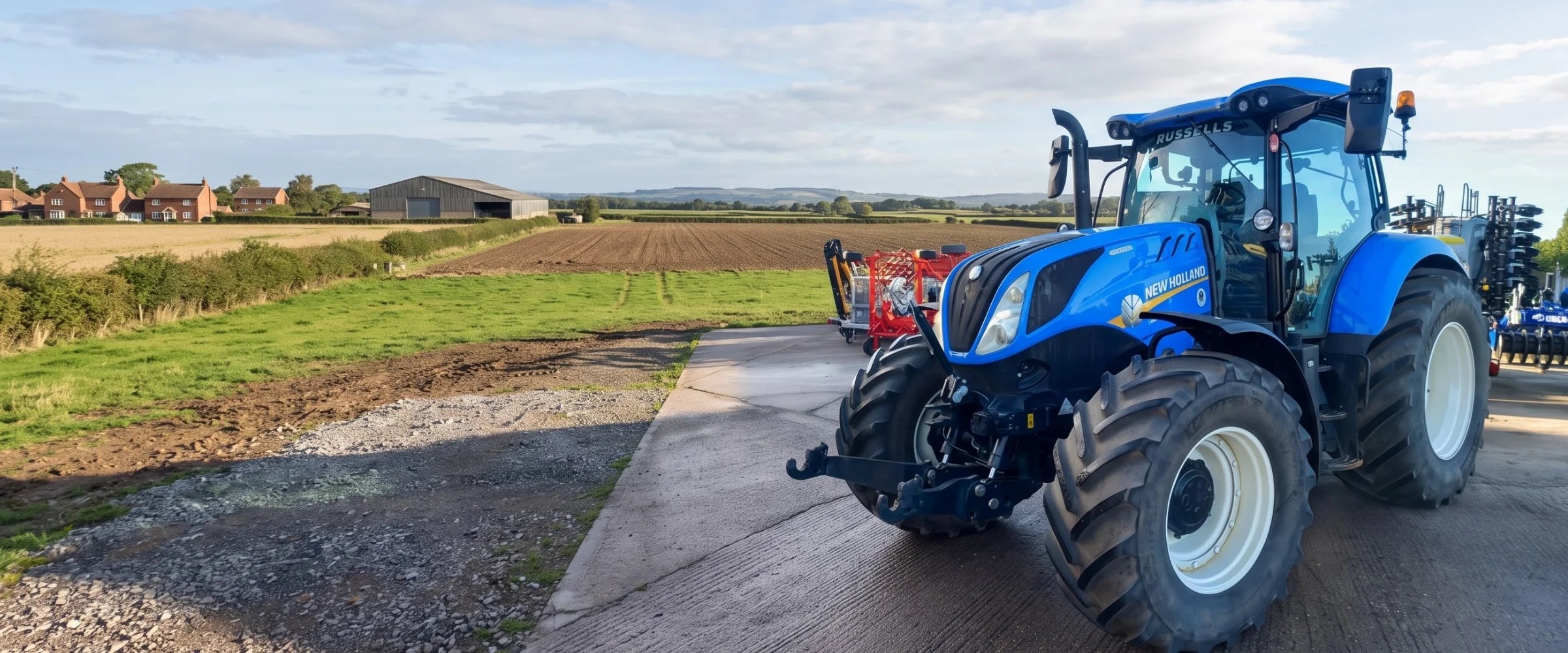 Tracteur New Holland T6.155 bleu sur un chemin de ferme