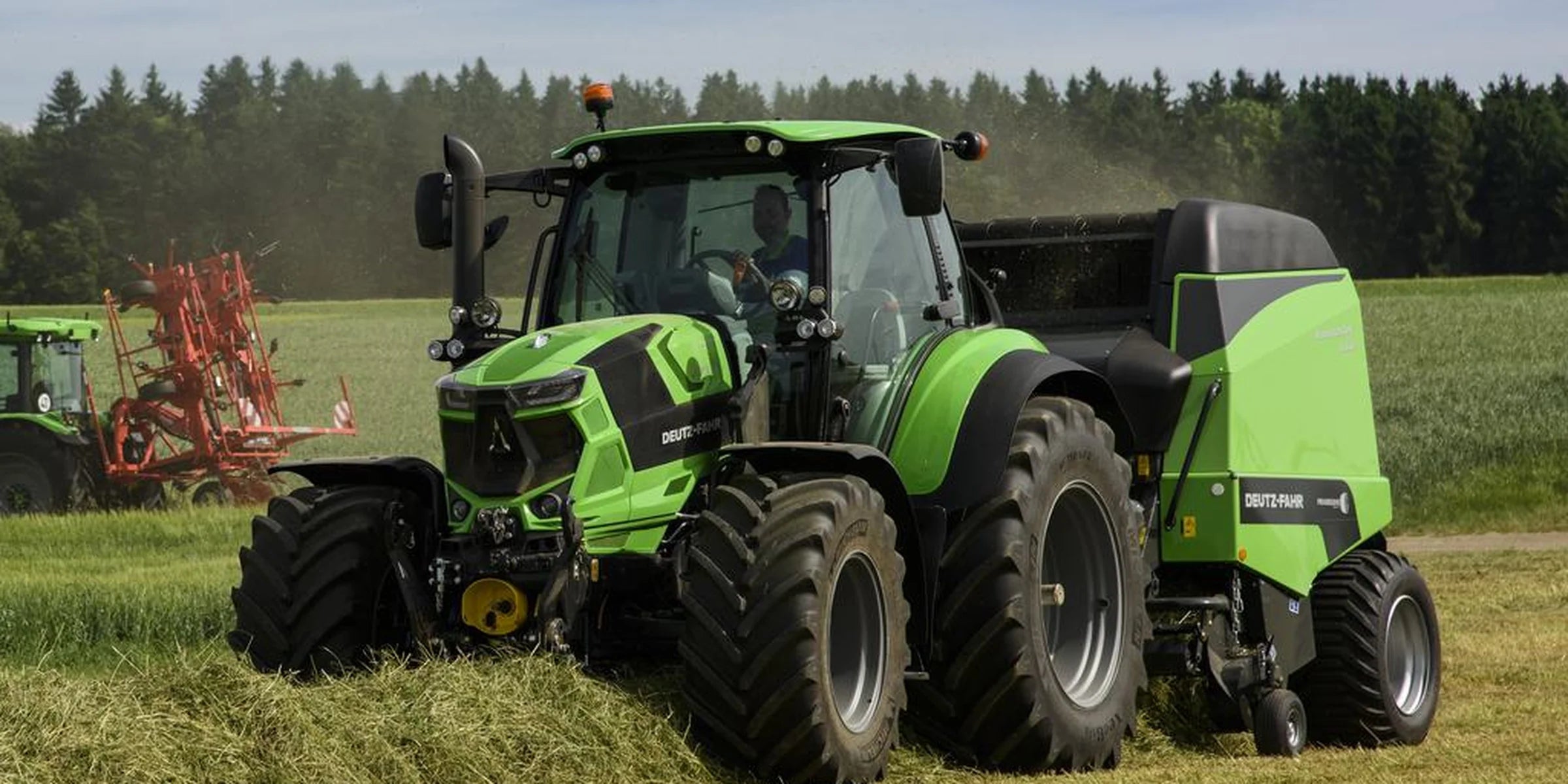 Green Deutz-Fahr tractor ploughing a field