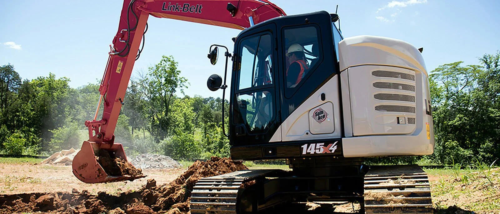 Link-Belt 145 X4 excavator digging a trench on a job site