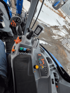 Poste de commandes du tracteur New Holland T6.155 2019 avec leviers, écrans et contrôles hydrauliques