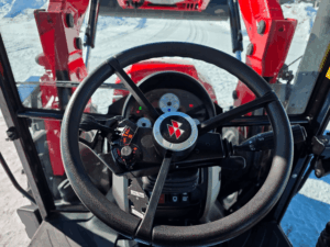 Massey Ferguson 4707 steering wheel with MF logo and integrated controls