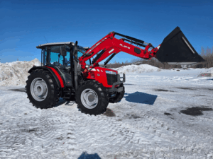 Massey Ferguson 4707 with bucket raised in snowy yard