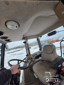 2004 Case IH MXM120 tractor cab interior with steering wheel and operator seat
