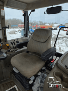 Interior view of the Case IH MXM120 tractor cab with operator seat and side console.