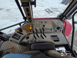 Vue intérieure du tracteur Case IH MXM120 montrant le volant, le siège opérateur et l’espace de travail dans la cabine.