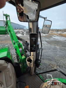 View from the operator seat showing visibility of the front loader on the John Deere 6110M.