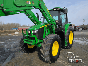 Front angle of the John Deere 6110M showing the front loader and cab.