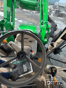 John Deere 6110M cab view with front loader
