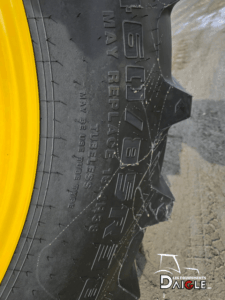 Detail of the John Deere 6110M tires showing good tread condition.