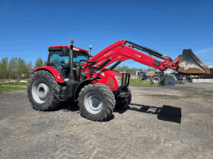 2019 McCormick X7.670 tractor with raised front bucket.