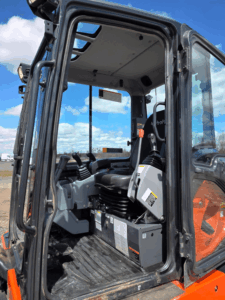 2021 Kubota KX057-4 excavator cab with hydraulic controls.