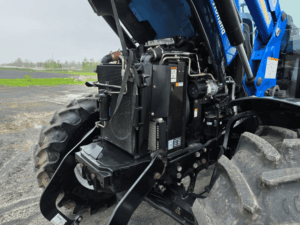 Engine compartment of the New Holland T6020 tractor with hood open.