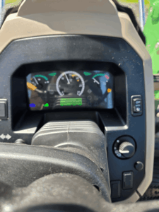 Dashboard and steering wheel of the 2019 John Deere 5075E tractor.
