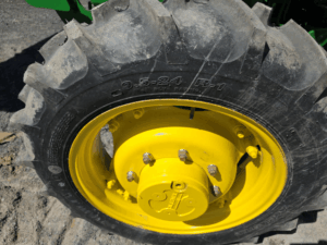 Front tire and yellow rim on the 2019 John Deere 5075E tractor.