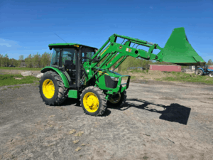 Front three-quarter view of the 2019 John Deere 5075E tractor with loader.