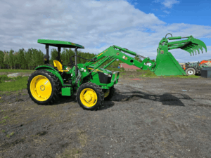 Left-side view of a John Deere 5075E tractor with front loader.