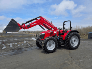 Red Massey Ferguson 5711 tractor with front loader side view on lot