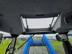 Panoramic roof window inside the New Holland T6020 tractor cab.