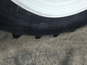 Rear tire size detail on the New Holland T6020 tractor.