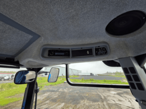 Interior roof console and mirrors inside the New Holland T6020 tractor cab.