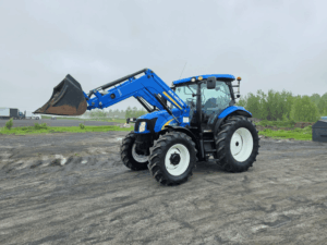 Front three-quarter view of a 2012 New Holland T6020 tractor with bucket loader.