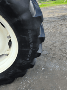 Rear agricultural tire on a New Holland TD95D tractor.