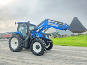 2022 New Holland T6.145 tractor with raised Quicke Q6M loader and bucket, ready to work.