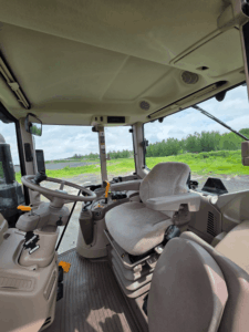 Interior of a 2021 John Deere 6120M tractor cab with suspension seat