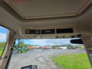 Factory radio and climate controls inside a Fendt 512 Vario cab