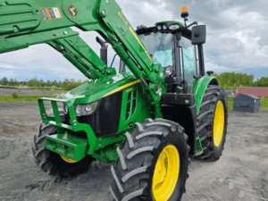 Front close-up of a 2020 John Deere 6110M tractor with 600R loader.