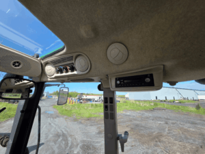 Audio and ventilation system inside the cab of a 2020 John Deere 5115M tractor.