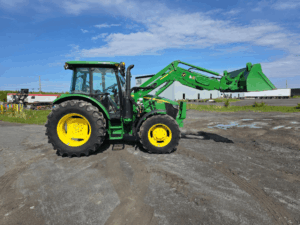 Full right-side profile of a 2020 John Deere 5115M tractor with cab.