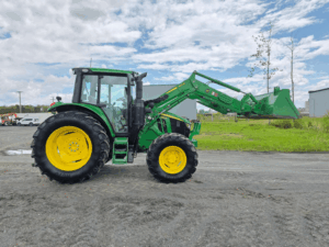 Right side profile of a 2020 John Deere 6110M tractor with cab and loader.