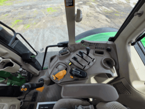 Interior of a 2021 John Deere 6120M tractor cab with suspension seat