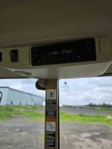 Factory-installed radio system inside a John Deere 6120M tractor cab