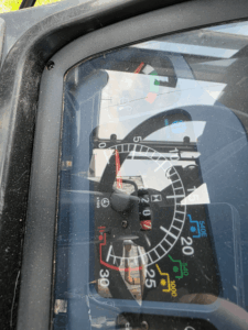 Dashboard and hour meter of a New Holland TD95D tractor.