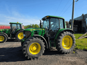 Used 2010 John Deere 6430 Premium tractor with enclosed cab viewed from the side at Les Équipements Daigle