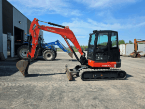 Used 2022 Kubota KX057-5 excavator with enclosed cab and rubber tracks at Les Équipements Daigle