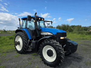 Used 2006 New Holland TM175 tractor viewed from the front right with front weights installed.