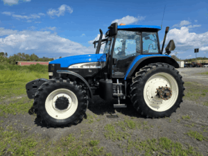 Used 2006 New Holland TM175 tractor viewed from the front left with front weights and suspended cab.