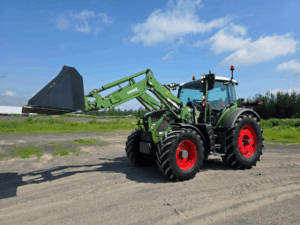 2021 Fendt 514 Vario with Fendt front loader and raised bucket, front left view.