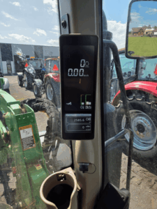 Digital display of a 2022 John Deere 6110M tractor showing 2,585.6 operating hours