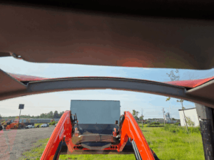 Forward view from inside the 2019 Kubota M5-111 cab with Kubota M32 loader