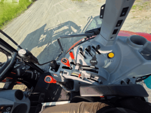 Hydraulic controls and operating levers inside the 2019 Kubota M5-111 tractor