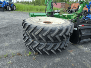 Rear dual agricultural wheels included with the 2006 New Holland TM175 tractor, ready to be installed.