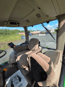 2016 John Deere 6145R cab interior with operator seat